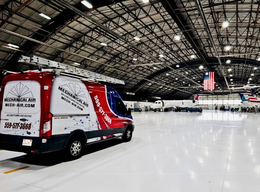 Mechanical Air van inside an aircraft hangar job site